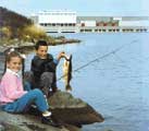 Photo of children fishing near power dam