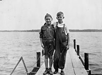Gerald Ford (left) and his cousin Gardner James display the day's catch from a fishing dock