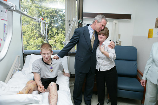 President George W. Bush hugs Anita Kukkola, the mother of PFC. Jason Kukkola of Fountain Hills, Ariz., Wednesday, Oct. 5, 2005, after he presented the soldier with a Purple Heart during a visit to Walter Reed Army Medical Center in Washington D.C. White House photo by Paul Morse