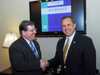 Public Printer Bob Tapella and OMB Director Jim Nussle view the first digital authentication of the Federal Budget.