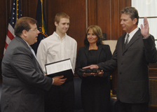 Public Printer Bob Tapella administers the oath of office to Deputy Public Printer Paul Erickson. Erickson’s son and wife, Clayton and Misty Erickson, look on.  The ceremony took place at the U.S. Government Printing Office in Washington, D.C.