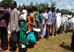 Photo of Ugandans waiting in line to have their nets treated to double their protection against malaria. (click here to see more)