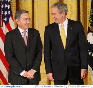 President George W. Bush stands with Colombian President Alvaro Uribe Tuesday, Jan. 13, 2009, during ceremonies honoring the 2009 Presidential Medal of Freedom Recipients in the East Room of the White House.  White House photo by Chris Greenberg
