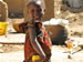 Photo of a young girl in Mali holding an apple. (click here to see more)
