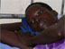 Photo of a young pregnant mother with a severe case of malaria resting in a hospital in Gulu, Uganda.  (click here to see more)