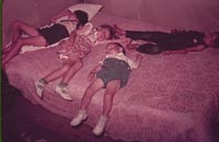 Children asleep on bed during square dance