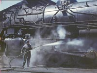 Mrs. Viola Sievers, one of the wipers at the roundhouse giving a giant class H locomotive a bath of live steam