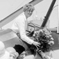 Amelia Earhart receives a bouquet of flowers upon arriving in Denver