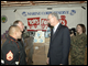 Deputy Secretary Ray Simon talks with Lt. General Pete Osman, USMC (ret.), President and CEO of the Marine Toys for Tots Foundation and Staff Sergeant Rodrigo Guzman, local U.S. Marine Reserve Toys for Tots coordinator about the 2008 Holiday Book Donation benefiting the Marine Toys for Tots Foundation.