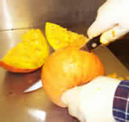 Photo: orange colored squash being cut up.