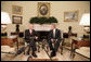 President George W. Bush meets with Andrew Natsios, U.S. Special Envoy for Sudan, in the Oval Office Monday, Oct. 2, 2006. White House photo by Eric Draper