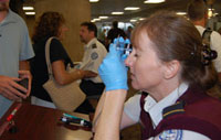 Photo of Julia Valentine, a TSO at Phoenix Sky Harbor, checking fraud-prevention features on a government-issued identification