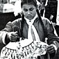 Photo of person looking at tribal dress on a coat hanger