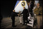 President George W. Bush is greeted as he deplanes Air Force One Monday, Dec. 15, 2008, after arriving in the pre-dawn hours in Afghanistan. The President visited with troops at Bagram Air Base, thanking them for their service and telling them, "I am proud to be with brave souls serving the United States of America." White House photo by Eric Draper