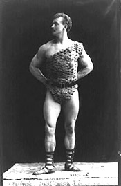 Photo: Muscular man posing in a leopard-printed outfit.