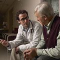 Young doctor and older gentleman in waiting room. Copyright 2008 Jupiterimages Corporation