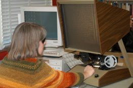 Researcher views documents on microfilm reader