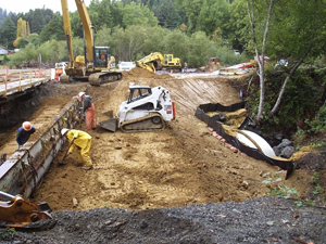 Contractors finishing the Warren Creek restoration, which included installing a large culvert, in Humboldt County, Calif.