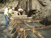 Contractors pour the foundation of a new much larger culvert in Humboldt County, Calif.