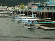 Small commercial float plane docked in marina