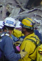 Rescuers confer in the aftermath of a disaster