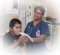 Nurse and boy patient.
		  	Photo Courtesy of the Indian Health Service/U.S. Department of Health and Human Services.