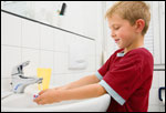 A boy washing his hands