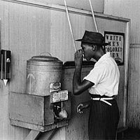 'Negro Drinking at 'Colored' Water Cooler in Streetcar Terminal, Oklahoma City, Oklahoma,' 1939.