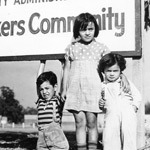 Group of Children Posing Under Sign.