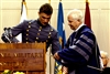 Class President Jason Webb of Bowie, Md., presents a saber to Defense Secretary Robert M. Gates during the Virginia Military Institute Graduation ceremony in Lexington, Va., May 16, 2008.  