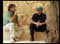 President George W. Bush listens to Eitan Campbell, Director of Masada National Park, as they take a break during their tour Thursday, May 15, 2008, of the historic Israeli fortress located on the eastern fringe of the Judean Desert near the shore of the Dead Sea. White House photo by Joyce N. Boghosian