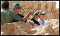 President George W. Bush and Mrs. Laura Bush stand with Mrs. Aliza Olmert, spouse of Israeli Prime Minister Ehud Olmert, as they listen to Eitan Campbell, Director of the Masada National Park, during a visit to the historic site Thursday, May 15, 2008, in Masada, Israel. White House photo by Joyce N. Boghosian