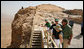 President George W. Bush and Mrs. Laura Bush stand with Mrs. Aliza Olmert, spouse of Israeli Prime Minister Ehud Olmert, as they listen to Eitan Campbell, Director of the Masada National Park, during a visit to the historic site Thursday, May 15, 2008, in Masada, Israel. White House photo by Joyce N. Boghosian