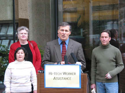 Group stands behind podium.