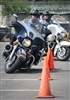 Pentagon motorcycle police officer Stephen Boyd leads Arlington County police officer through a series of cones during a cycling demonstration at the second annual National Capital Region Joint Services motorcycle safety event held at the Pentagon, May 2, 2008.