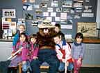 Young visitors cluster around Smokey the Bear at the Petersburg Visitor Center.