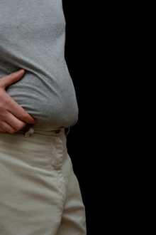 image of a man pinching his belly.