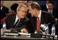 President George W. Bush speaks with European Union High Representative Javier Solana during a plenary session of the North Atlantic Council at NATO Headquarters in Brussels Tuesday, Feb. 22, 2005. White House photo by Eric Draper