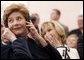 Laura Bush listens to translation headphones during a joint press conference with President George W. Bush and German Chancellor Gerhard Schroeder at the Electoral Palace in Mainz, Germany, Wednesday, Feb. 23, 2005. The Chancellor’s wife, Mrs. Schroeder-Koepf is seated next to Mrs. Bush. White House photo by Eric Draper