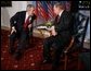 President George W. Bush leans in to speak with Russia President Vladimir Putin Thursday, Feb. 24, 2005 during a photo opportunity in Bratislava, Slovakia. The meeting of the two leaders marked the last during President Bush's five-day European trip. White House photo by Eric Draper