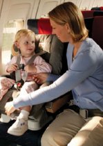 Child with Mother in child restraint system on a plane