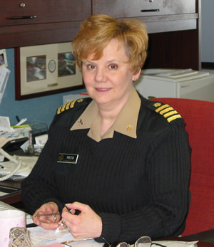 Image of a women in uniform sitting at a desk