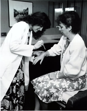 Image of a woman in a doctor's office getting a shot