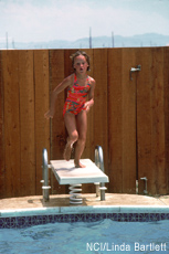 Photograph of a girl jumping into a swimming pool
