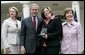 President George W. Bush is joined by Secretary of Education Margaret Spellings and Mrs. Laura Bush as they congratulate the 2007 National Teacher of the Year, Andrea Peterson, during ceremonies Thursday, April 26, 2007, in the Rose Garden. Mrs. Peterson is a music teacher at Monte Cristo Elementary School in Granite Falls, Washington. White House photo by Eric Draper