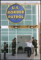 President George W. Bush waves from the new Yuma Border Patrol Station building Monday, April 9, 2007, during his visit to the Arizona border community to speak on immigration reform. The President told his audience, "We need to work together to come up with a practical solution to this problem, and I know people in Congress are working hard on this issue." White House photo by Eric Draper