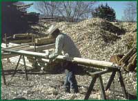 Photo: Man working cutting lumber.