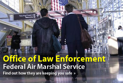 image of two people walking through an airport terminal.