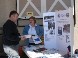 Mitigation Outreach team visiting with home building storm customer.