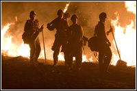 A Northern California fire crew works into the night clearing fire line and monitoring the back burn that was set to stop the Poomacha fire from advancing westward. Currently the fires in Southern California have burned more than 355,000 acres. Andrea Booher/FEMA
